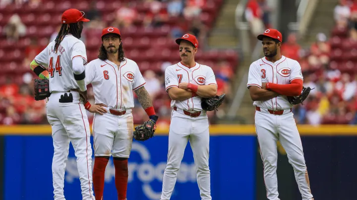 Cincinnati Reds infielders Elly De La Cruz, Jonathan India, Spencer Steer, and Jeimer Candelario gather near the mound in between innings at Great American Ballpark.